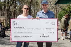 Chaser in East Hampton store manager Kurt Markowski presents ARF with money raised from their charity tees!