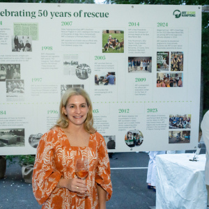 Michele Backman in front of the ARF history timeline. Photo by Mark Kopko Photography.