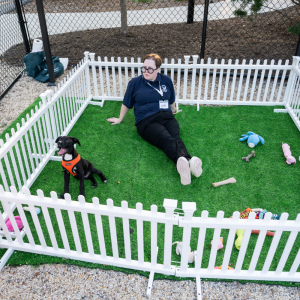 ARF's Lindsay Begg mans the puppy pen. Photo by Mark Kopko Photography.