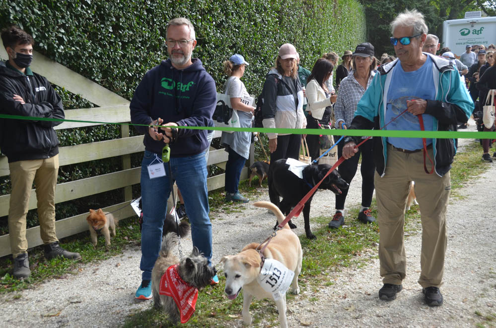 Majo Prazenec and his dog Buddy, last year's top fundraiser, cuts the ribbon this year.