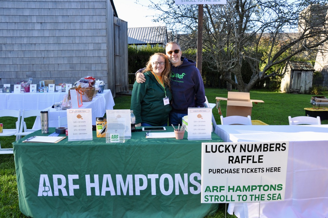 Volunteers Heather Zwicker and Majo Prazenec man the Lucky Numbers Raffle table.