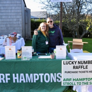 Volunteers Heather Zwicker and Majo Prazenec man the Lucky Numbers Raffle table.
