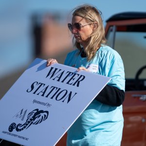 Volunteer Suzanne Siracuse sets up the water station at the beach. Thank you Hamptons Expert Painting - Dog Walk Water Station Sponsor. Photo by Craig Macnaughton.