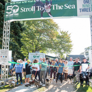 2023 Top Fundraiser Majo Prazenec cuts the ribbon to start this year\'s dog walk! Photo by Lisa Tamburini.