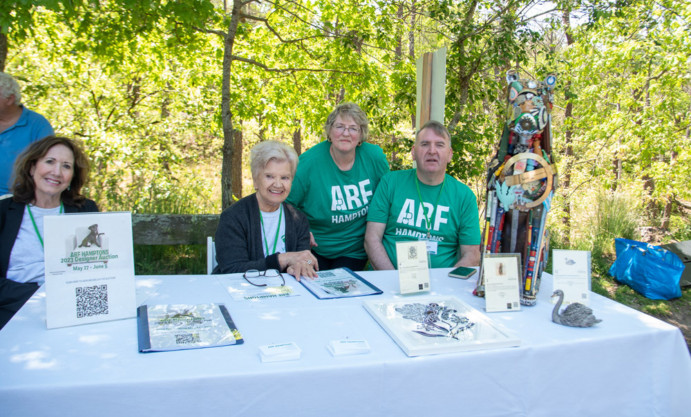 ARF Thrift Shop manager Gary Mannes (on right) and volunteers Jackie Falkowski, Pat Sheahan and Joan Salazar help promote the designer online auction.