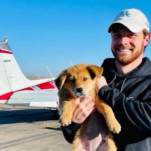 Pilot Matt Pellegrino and puppy are all smiles for the flight.