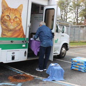 ARF and O-Cat Volunteer Donald Martin helps load the cats on the mobile spay /neuter van.